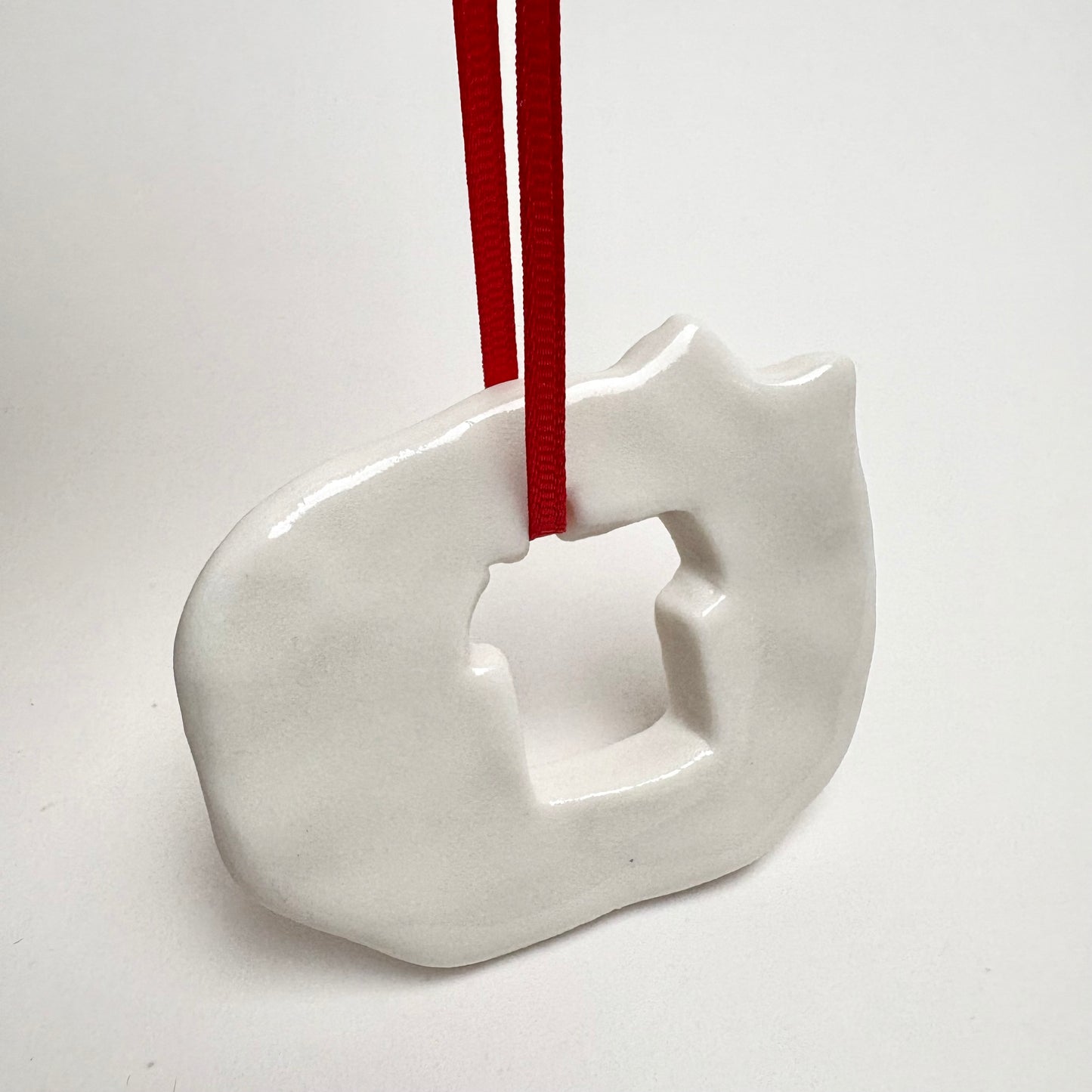 Handmade Porcelain Cat Christmas Ornament with Cutout, White Glazed Ceramic Holiday Decoration with Red Ribbon, Minimalist Winter Decor