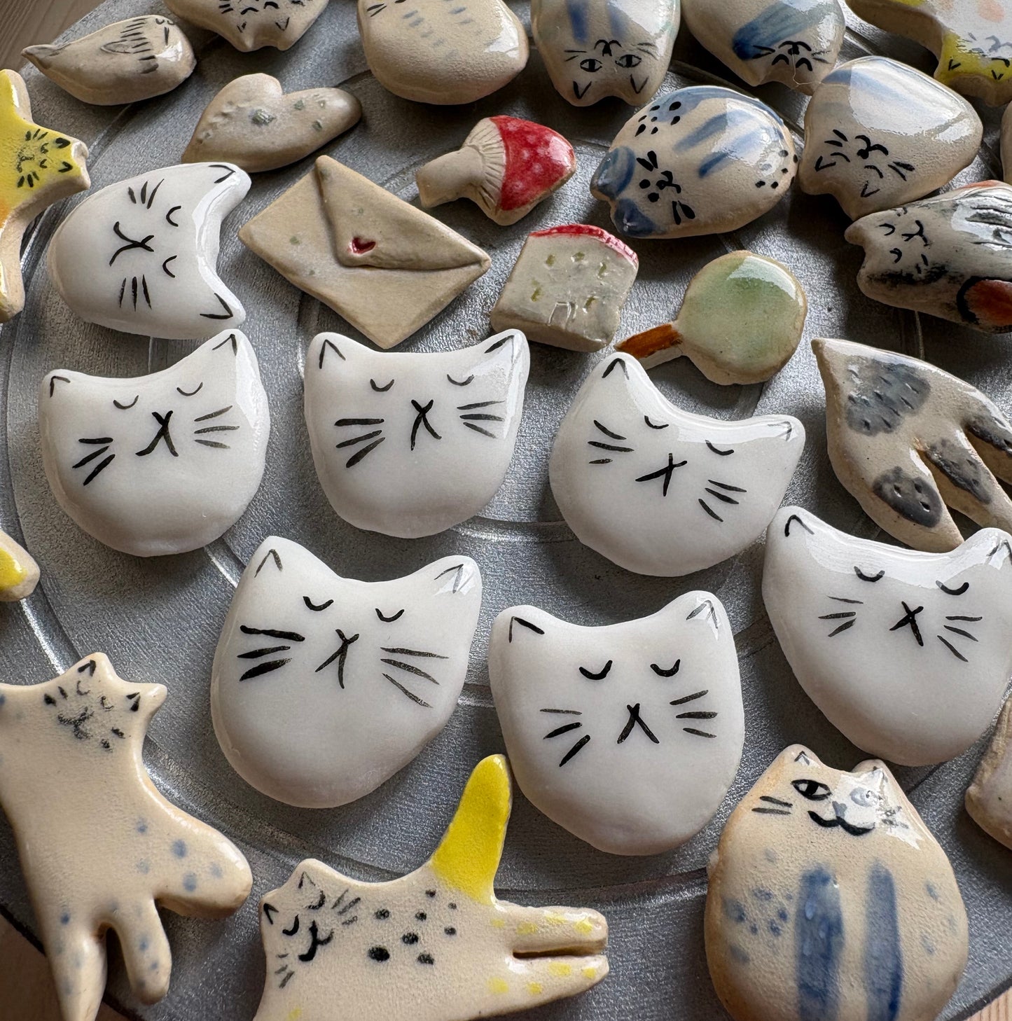 Tiny porcelain white kitty head magnets