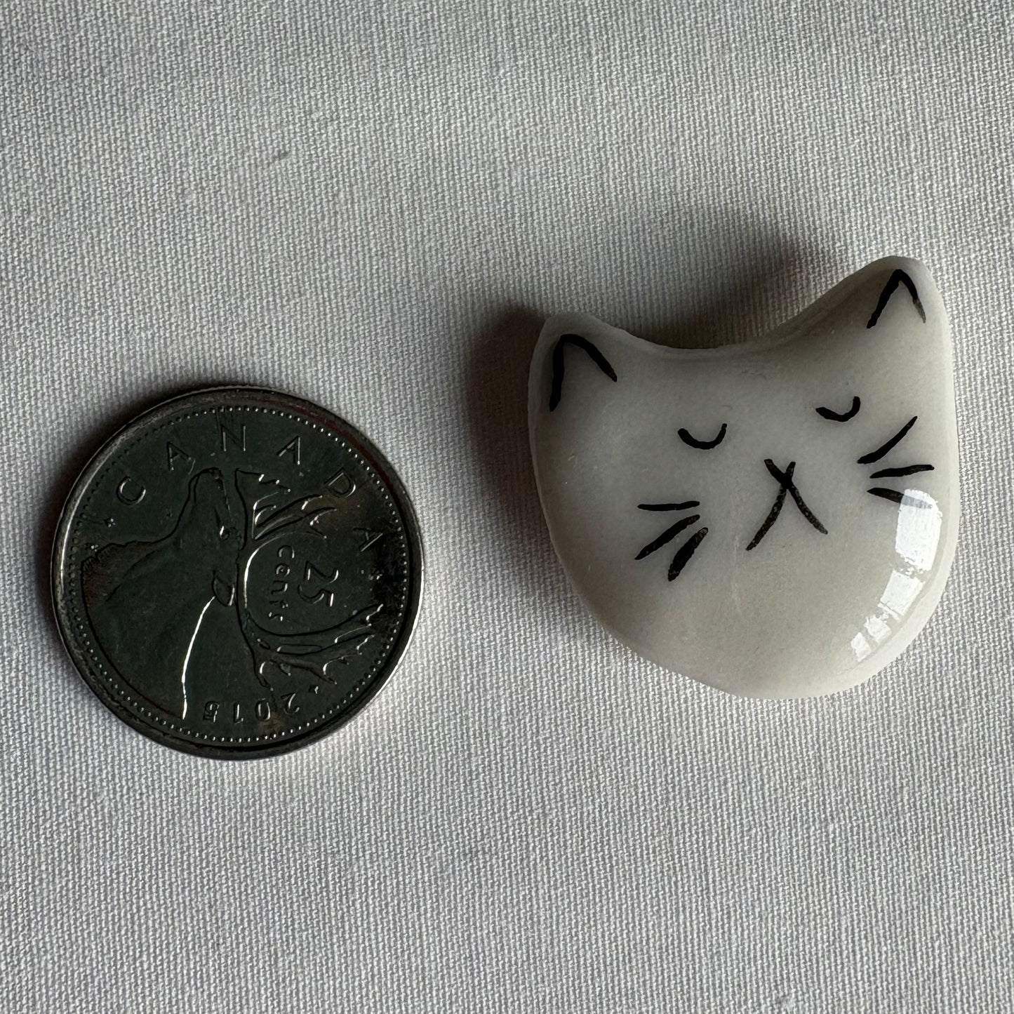 Tiny porcelain white kitty head magnets