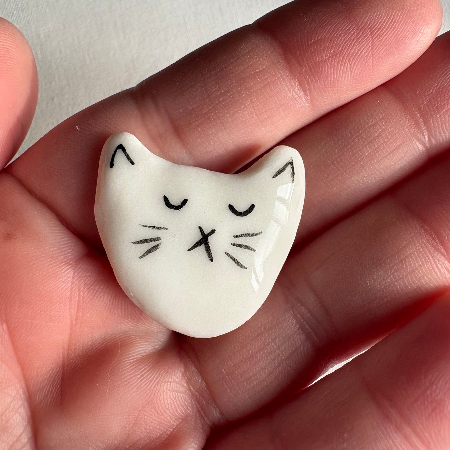 Tiny porcelain white kitty head magnets
