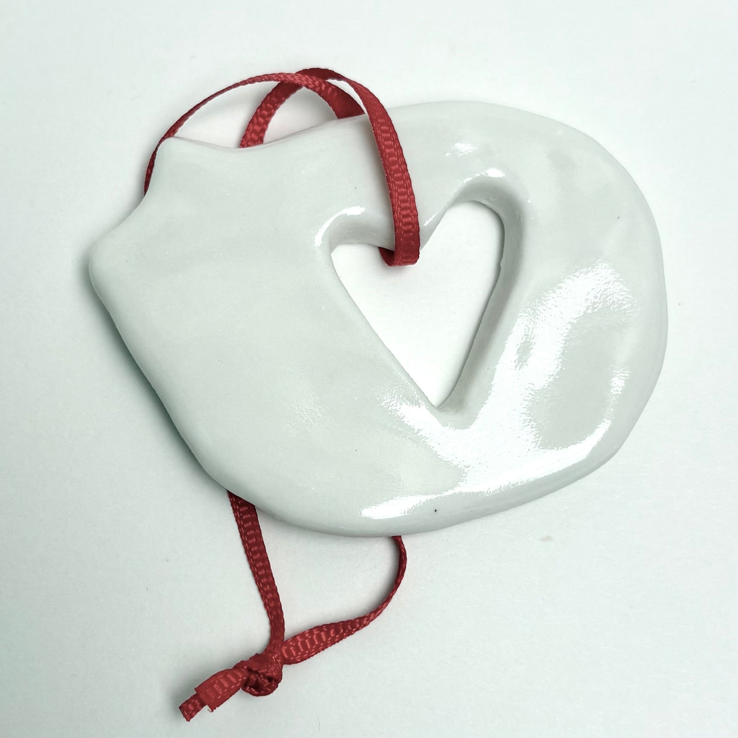 Handmade Porcelain Cat Christmas Ornament with Cutout, White Glazed Ceramic Holiday Decoration with Red Ribbon, Minimalist Winter Decor