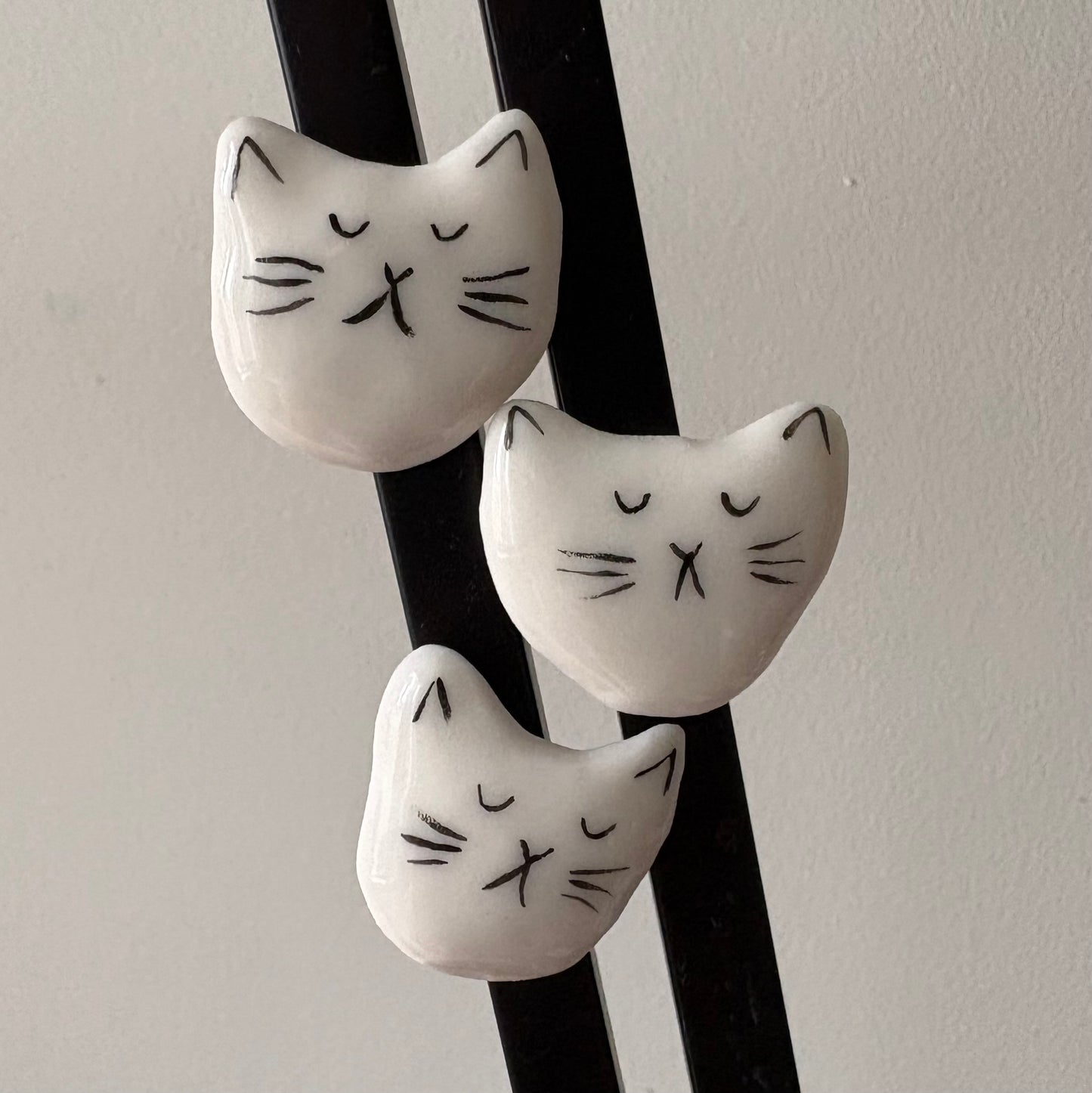 Tiny porcelain white kitty head magnets