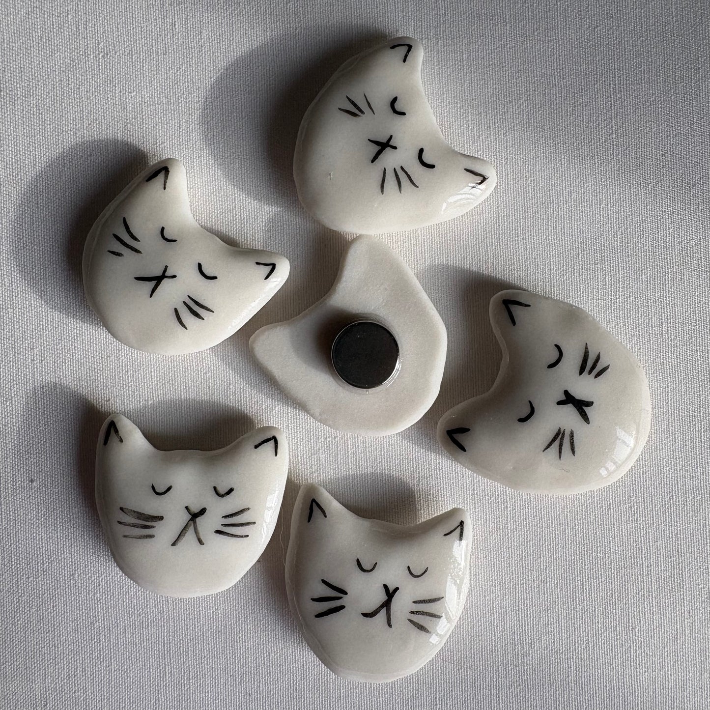 Tiny porcelain white kitty head magnets