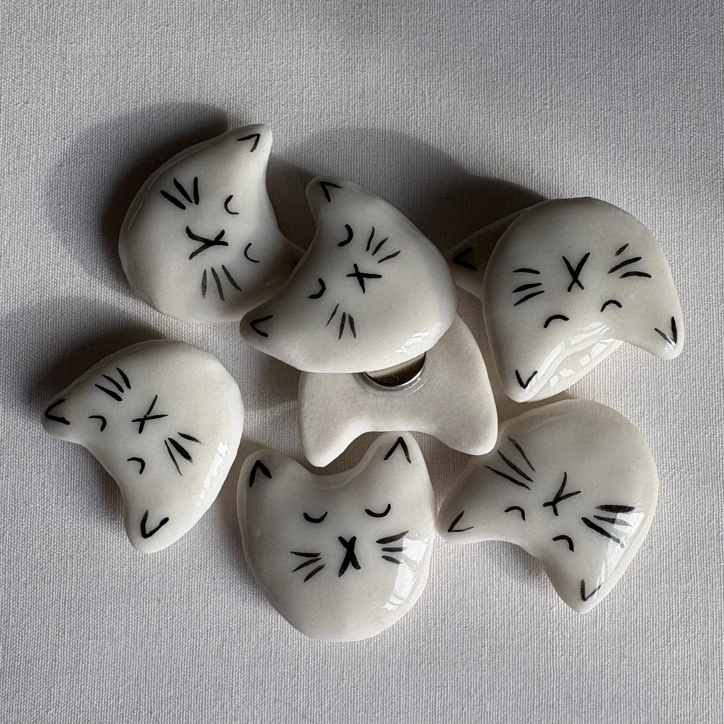 Tiny porcelain white kitty head magnets