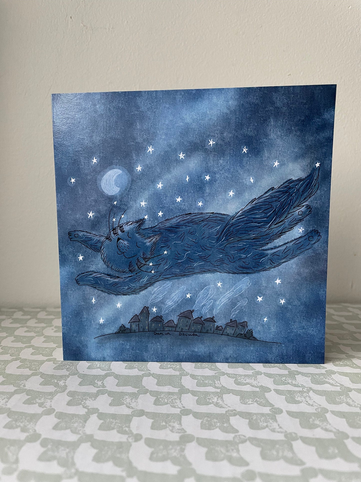 Cat flying over a city: Greeting card